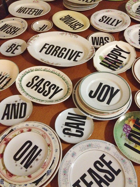 Paper letters applied and varnished on vintage plates by Susan McCaslin. Plates can be arranged to form phrases. 